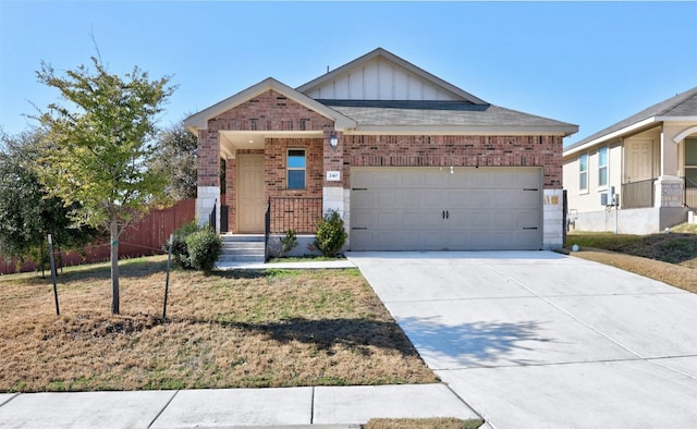 single story home with fence, driveway, an attached garage, board and batten siding, and brick siding