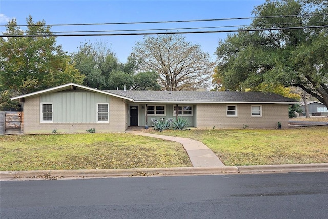 ranch-style house with brick siding and a front yard