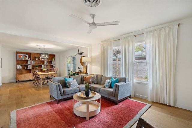 living room featuring hardwood / wood-style floors and ceiling fan