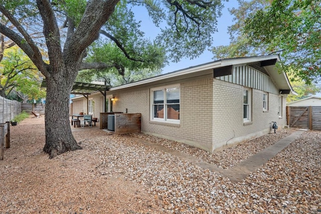 view of side of property with a pergola