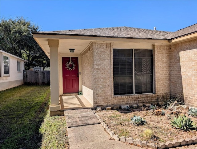 entrance to property with a lawn