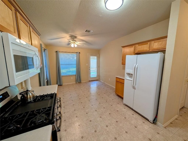 kitchen featuring ceiling fan, white appliances, and a textured ceiling