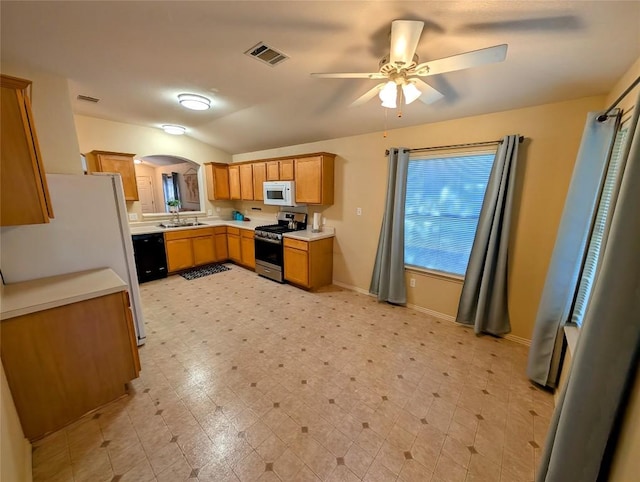 kitchen with sink, white appliances, and ceiling fan