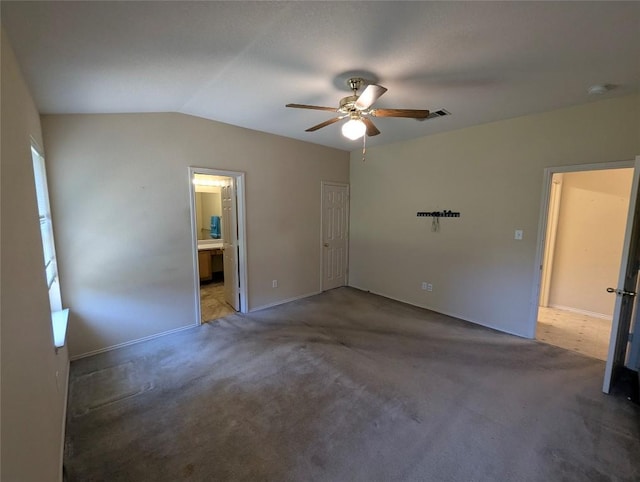 empty room with lofted ceiling, dark carpet, and ceiling fan