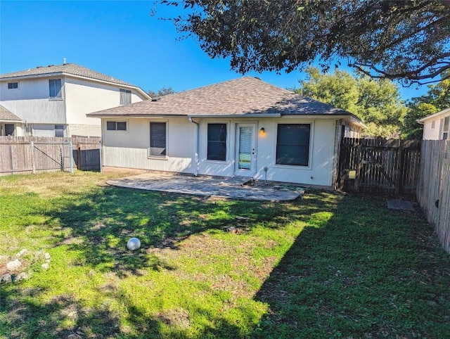 back of property featuring a patio area and a lawn