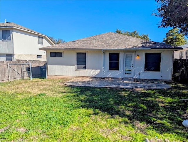 rear view of house with a yard and a patio