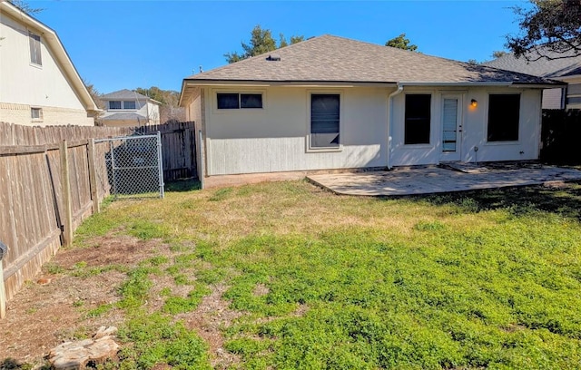 rear view of property featuring a patio and a lawn