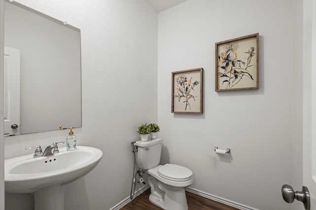 bathroom featuring sink, hardwood / wood-style floors, and toilet