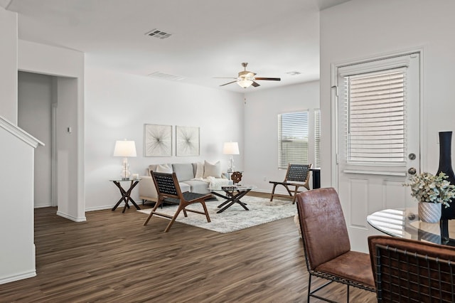 living room featuring dark hardwood / wood-style floors and ceiling fan