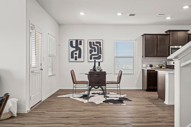 dining room with dark wood-type flooring