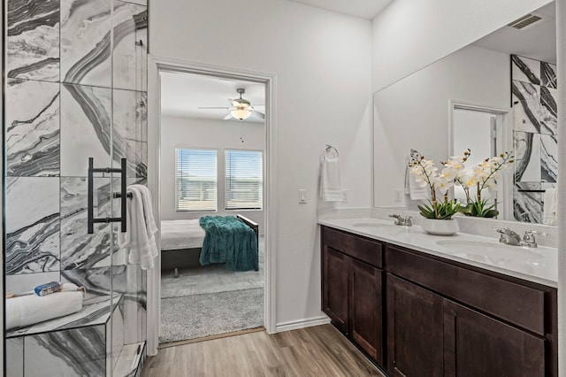 bathroom with ceiling fan, vanity, and wood-type flooring