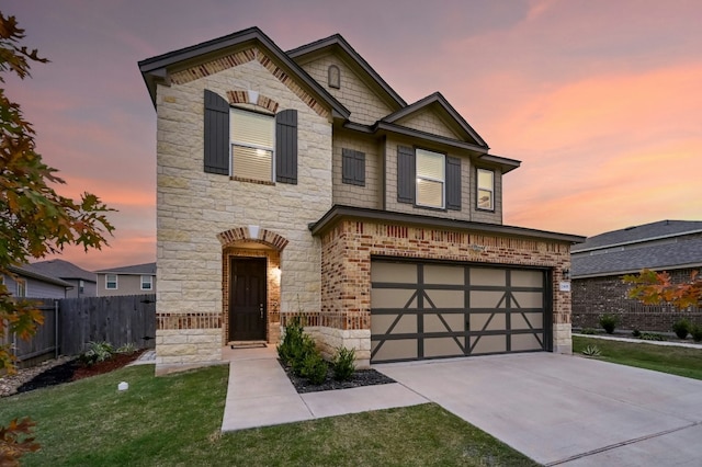 view of front of property with a garage and a yard