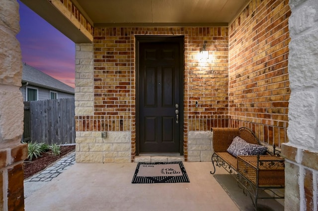 view of exterior entry at dusk