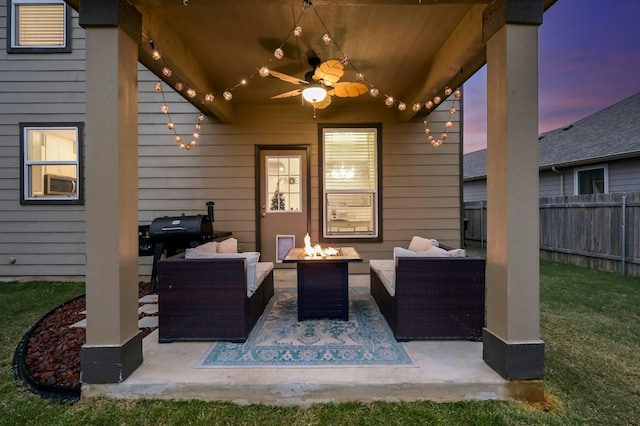 patio terrace at dusk featuring a grill, an outdoor living space with a fire pit, and ceiling fan