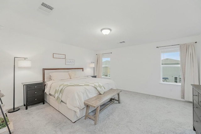 carpeted bedroom featuring multiple windows