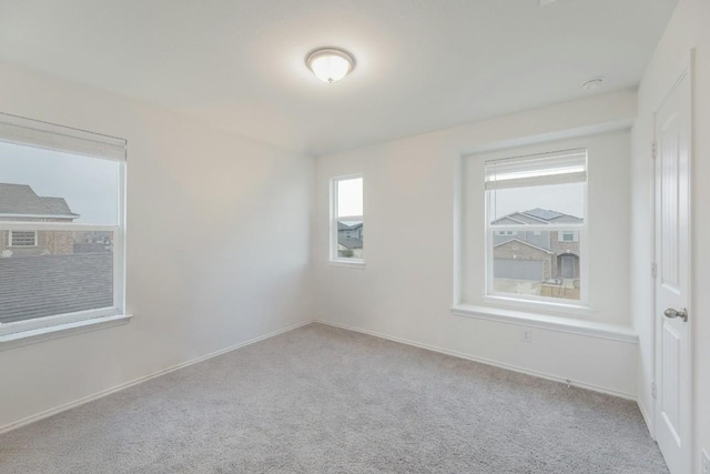 unfurnished room with light carpet