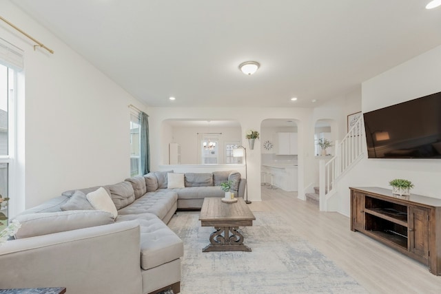 living room with a chandelier and light hardwood / wood-style floors