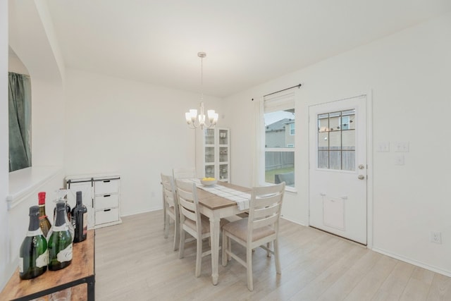 dining area featuring a chandelier and light hardwood / wood-style floors