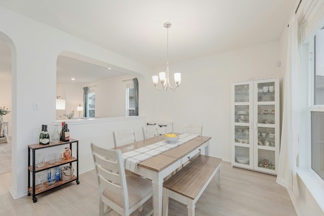 dining area featuring a chandelier and light wood-type flooring