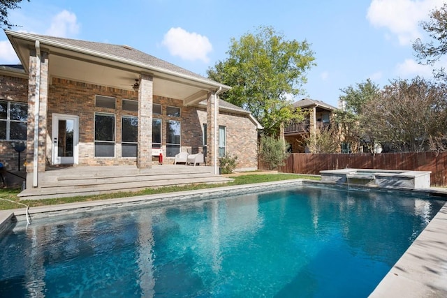 view of pool with a patio, ceiling fan, and an in ground hot tub