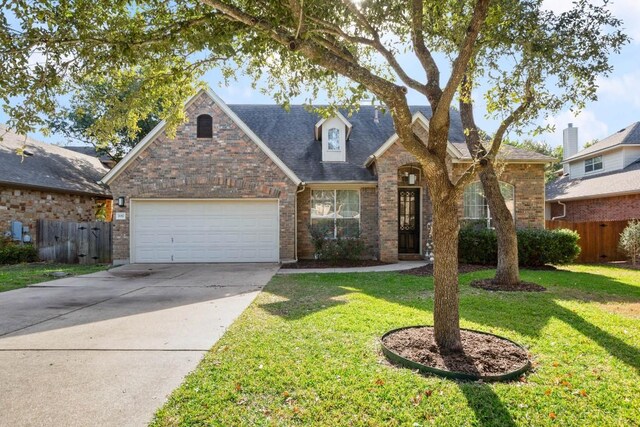 7017 Viridian Ln, Austin, TX 78739 - traditional home with brick siding, a garage, concrete driveway, and roof with shingles