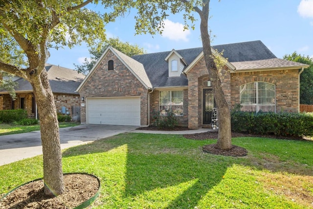 view of front of property with a garage and a front yard