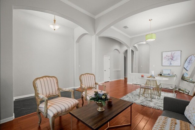 7017 Viridian Ln, Austin, TX 78739 - living room with arched walkways, wood finished floors, crown molding, and baseboards