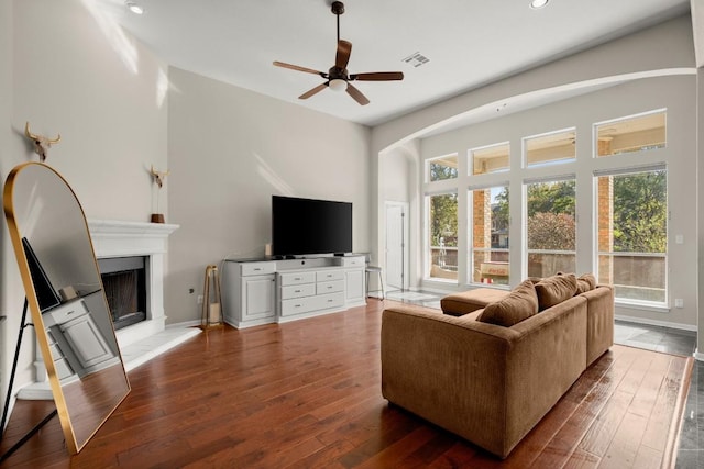 living room featuring ceiling fan and dark hardwood / wood-style flooring