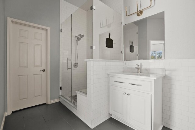 7017 Viridian Ln, Austin, TX 78739 - bathroom with a stall shower, tile patterned flooring, tile walls, and vanity