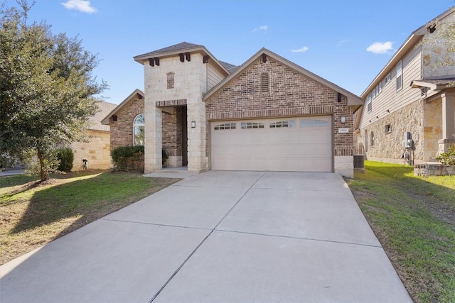 view of front of home featuring a garage and a front lawn