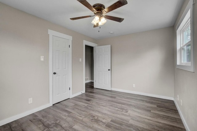 unfurnished bedroom with hardwood / wood-style floors and ceiling fan