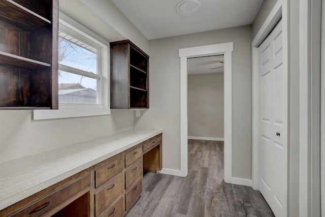 interior space featuring built in desk and light hardwood / wood-style flooring