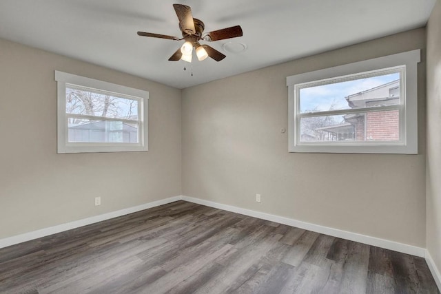 empty room with hardwood / wood-style floors, a wealth of natural light, and ceiling fan