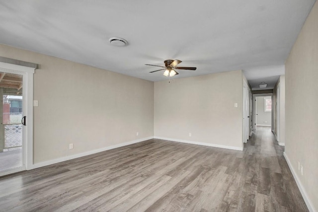 spare room with hardwood / wood-style flooring and ceiling fan