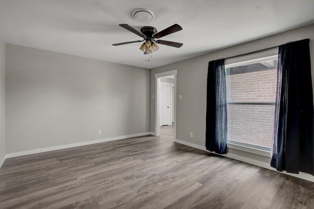 empty room with hardwood / wood-style flooring and ceiling fan