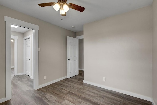 unfurnished room with wood-type flooring and ceiling fan