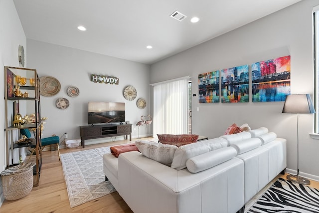 living room with light hardwood / wood-style flooring