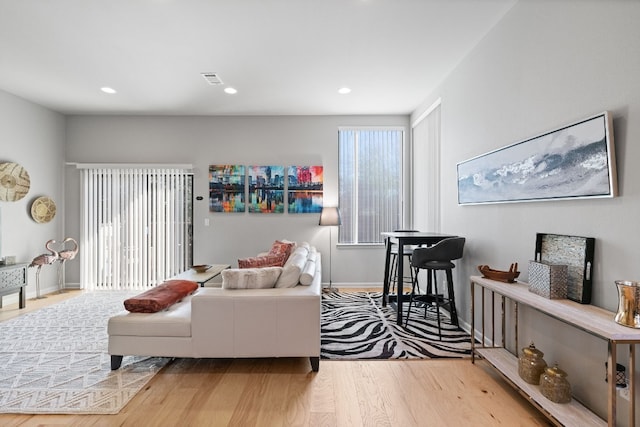 living room with a wealth of natural light and light wood-type flooring