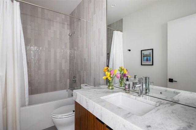 full bathroom featuring vanity, shower / bath combination with curtain, and toilet