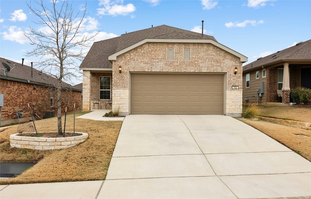 722 Kitty Hawk Rd, Georgetown, TX 78633 - view of front of property featuring brick siding, concrete driveway, a garage, a shingled roof, and stone siding