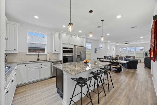 722 Kitty Hawk Rd, Georgetown, TX 78633 - kitchen with appliances with stainless steel finishes, light stone countertops, tasteful backsplash, white cabinetry, and recessed lighting