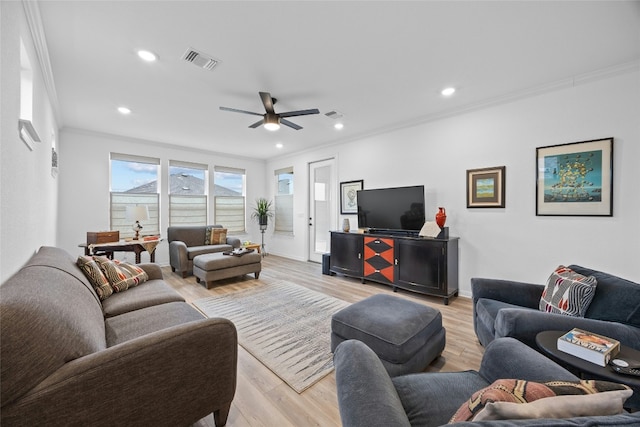 living room featuring crown molding, ceiling fan, and light hardwood / wood-style floors