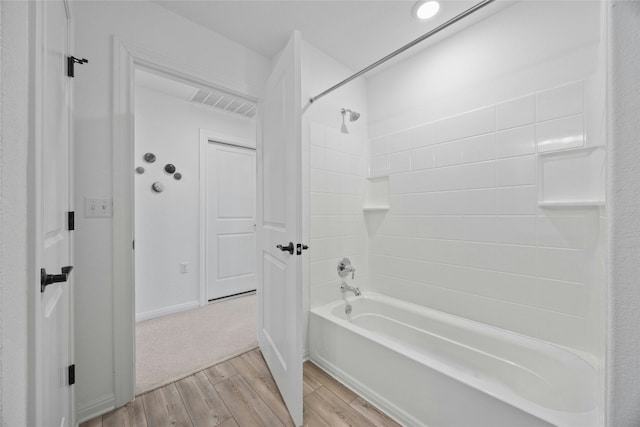 bathroom featuring  shower combination and wood-type flooring