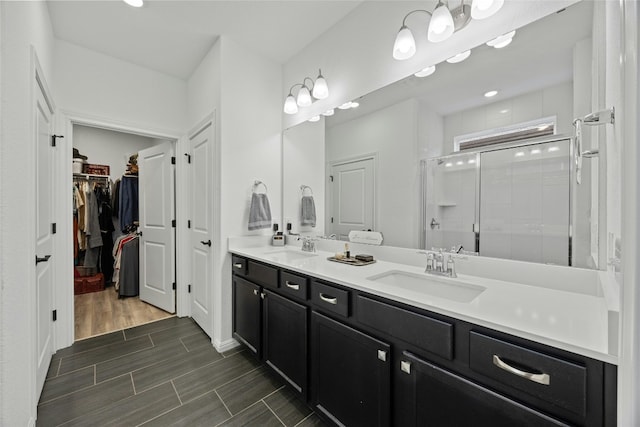722 Kitty Hawk Rd, Georgetown, TX 78633 - full bath with double vanity, a shower stall, a spacious closet, and wood finish floors