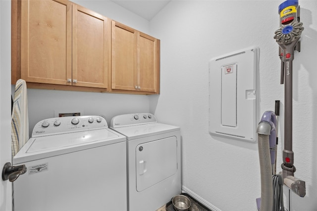 clothes washing area with cabinets, electric panel, and washing machine and dryer