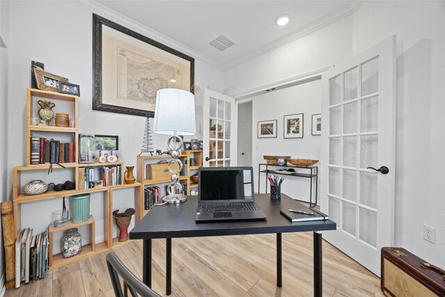 home office with ornamental molding, light hardwood / wood-style floors, and french doors