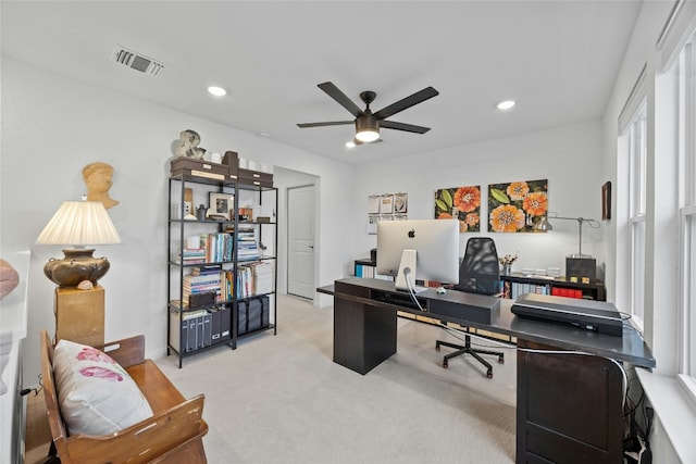 carpeted office space featuring ceiling fan