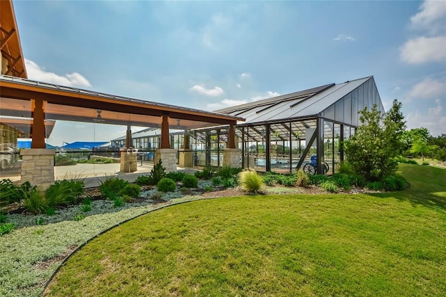 view of yard with a patio and glass enclosure