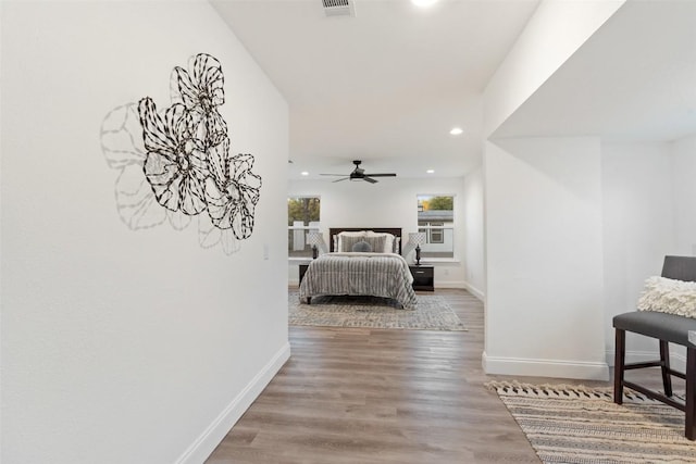 bedroom featuring recessed lighting, visible vents, baseboards, and wood finished floors