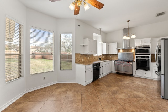 kitchen with appliances with stainless steel finishes, hanging light fixtures, backsplash, white cabinets, and ceiling fan with notable chandelier